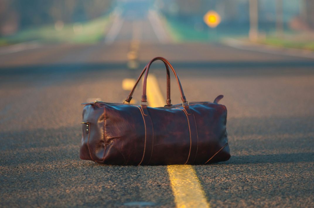 Leather duffel bag product photo before AI upscaling